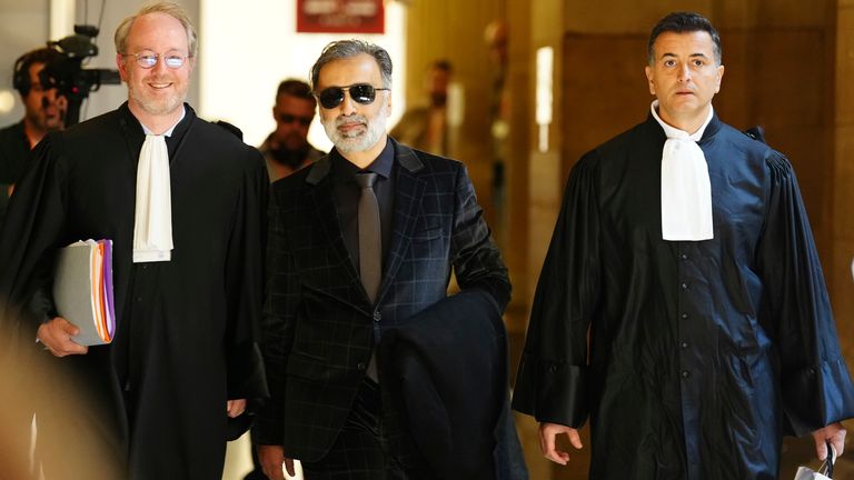 Abderrahmane Ouatiki, center, who was working as a hotel receptionist and was allegedly held at gunpoint by the robbers during the 2016 armed robbery of Kim Kardashian, arrives at the palace of justice Monday, April 28, 2025 in Paris. (AP Photo/Aurelien Morissard)