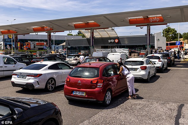 Drivers wait in line to fill up their vehicles with fuel at a service station in Portugal