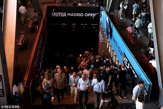 Tennis fans are seen after matches were suspended at the Madrid Open due to a power outage