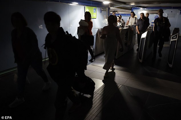 Commuters leave a subway station after a blackout hit Spain and Portugal, in Madrid
