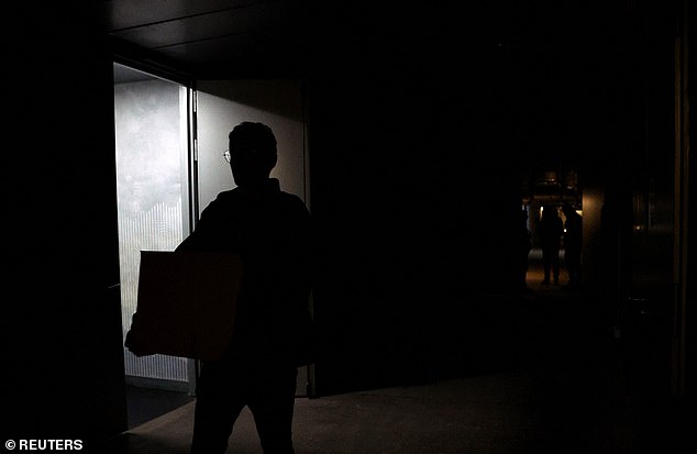 A person is seen in a dark corridor after matches are suspended at Madrid Open due to a power outage