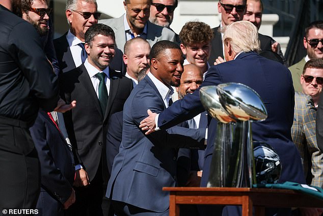 Trump and Philadelphia Eagles' running back Saquon Barkley shake hands at the White House
