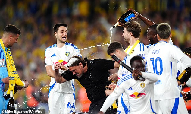 Boss Daniel Farke, whose future at the club is in doubt, can't escape the spray of the bubbly