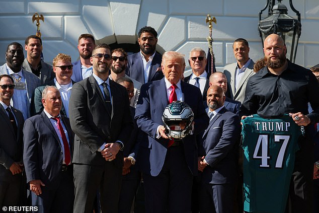Trump poses with the Eagles team after welcoming them to the White House on Monday