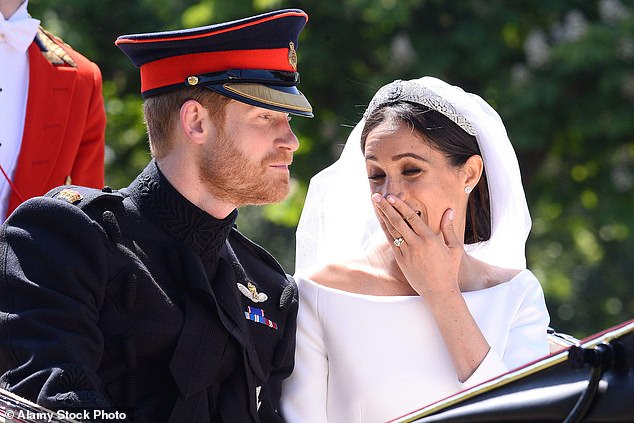 Meghan is pictured with Prince Harry on their wedding day in 2018