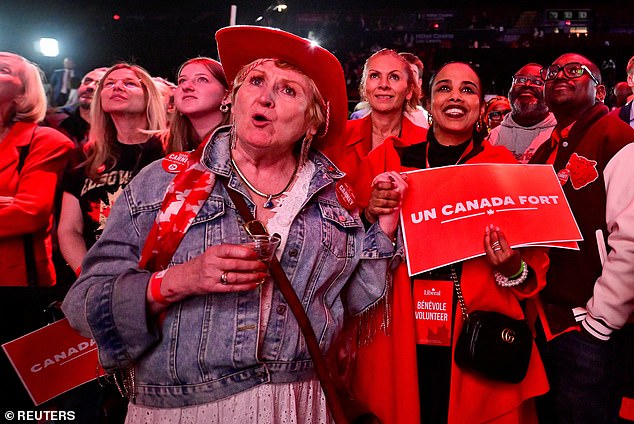 Dorothy Goubault, a supporter of Canada's Prime Minister Mark Carney, reacts to polling numbers at the Liberal Party election night headquarters in Ottawa