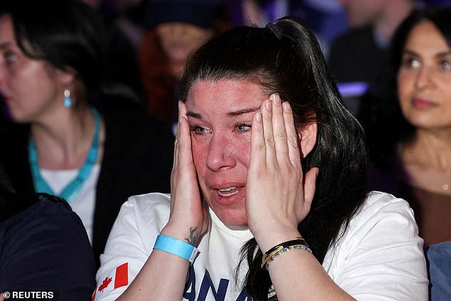 Amanda Mainville, a government worker and supporter of Conservative Party of Canada's leader Pierre Poilievre, reacts as news media calls the election for the Liberal Party