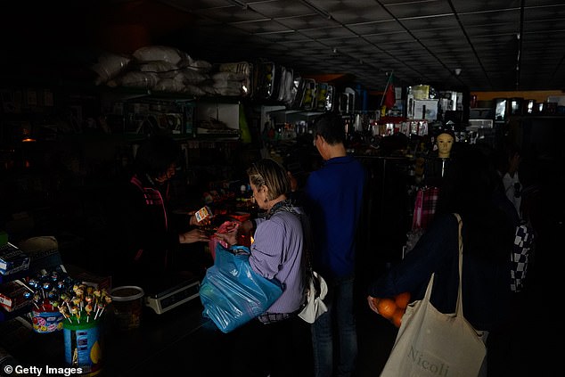 Yesterday, Spain and Portugal were hit by cascading power outages which caused widespread blackouts. Pictured: People shop for groceries during a shutdown of electricity