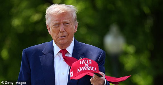 WASHINGTON, DC - APRIL 29: U.S. President Donald Trump holds a hat as he walks to speak to members of the media before boarding Marine One on the South Lawn of the White House on April 29, 2025 in Washington, DC. Trump will travel to Michigan for a 100th Day in Office rally. (Photo by Andrew Harnik/Getty Images)