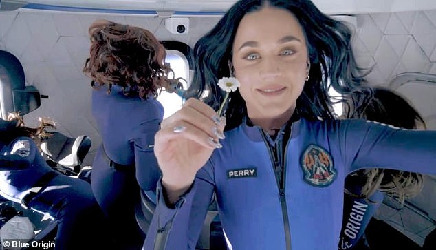 'I feel so connected to love': Katy Perry clutched a daisy during the spaceflight in a tribute to her daughter, Daisy, whose father is English actor Orlando Bloom
