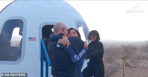 Jeff Bezos embraces Lauren Sanchez as she comes out of the capsule in which she, Pop star Katy Perry, journalist Gayle King, and other participants, landed back on earth after blasting off into space on a Blue Origin rocket, as part of the New Shepard Mission NS-31, marking the first all-female flight crew in more than six decades, in West Texas, Texas, U.S., April 14, 2025, in this screen grab taken from a video. Blue Origin/Handout via REUTERS    THIS IMAGE HAS BEEN SUPPLIED BY A THIRD PARTY. NO RESALES. NO ARCHIVES. MANDATORY CREDIT
