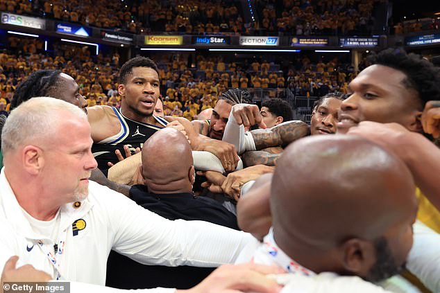 Kevin Porter Jr. (back right) enters the fray as Pacers players restrain Mathurin (right)