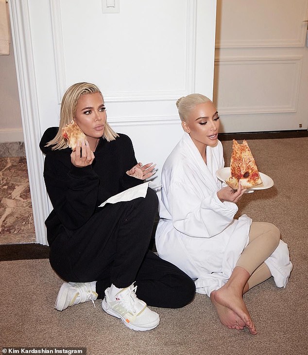 Although, Khloé admitted she would 'never' eat a full large pizza (pictured with sister Kim after the 2022 MET Awards)