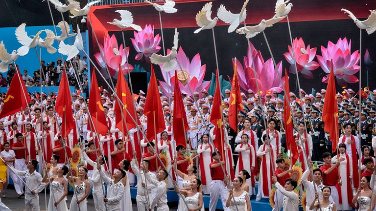Vietnamese performers participate in a parade celebrating the 50th anniversary of the end of the war on Wednesday, April 30, 2025, in Ho Chi Minh City, Vietnam. (AP Photo/Richard Vogel)