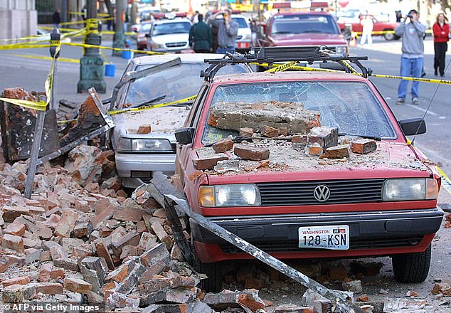 Pictured: Parked cars were rained with falling bricks from nearby building after a 6.8 magnitude earthquake hit Seattle on February 28, 2001