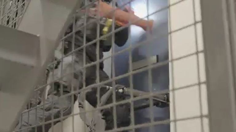 The moment armed police smashed in the door of where Downes was staying in a dawn raid before arresting him