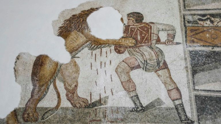 An ancient Roman mosaic depicting a gladiator fighting a lion. Pic: Reuters