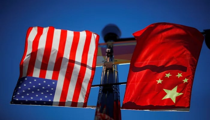 The flags of the United States and China fly from a lamppost in the Chinatown neighbourhood of Boston, Massachusetts, US, November 1, 2021. — Reuters