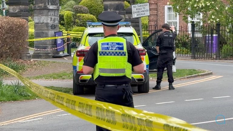 Officers guard one of the crime scenes in Leeds