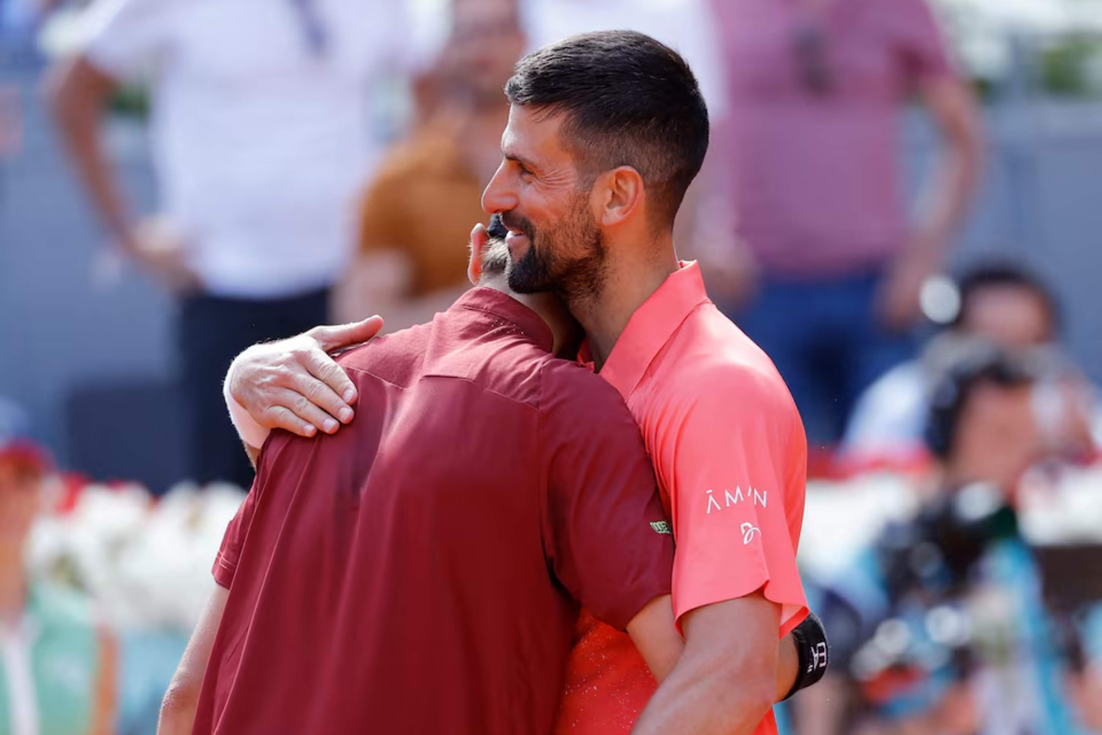 Italys Matteo Arnaldi hugs Serbias Novak Djokovic after winning his round of 64 match in Madrid Open at Park Manzanares, in Madrid, Spain on  April 26, 2025. — Reuters