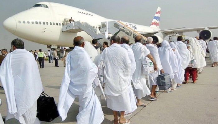 Pakistani Muslim pilgrims walk towards a waiting plane at Lahore International airport bound for Saudi Arabia to perform the annual Hajj pilgrimage.— AFP/File