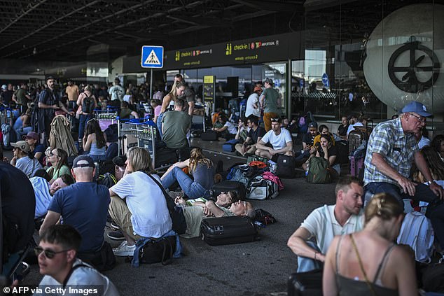 The power outage caused massive disruption as trains were cancelled and planes were grounded. Pictured: People wait outside Humberto Delago airport in Lisbon, Spain