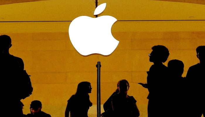 Customers walk past an Apple logo inside of an Apple store at Grand Central Station in New York, US. — Reuters
