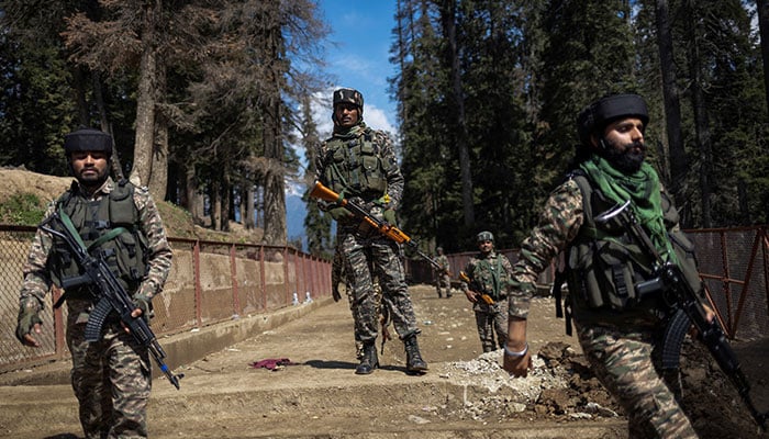 Indian security force personnel stand guard at the site of a suspected militant attack on tourists in Baisaran near Pahalgam in IIOJKs Anantnag district, April 24, 2025. — Reuters