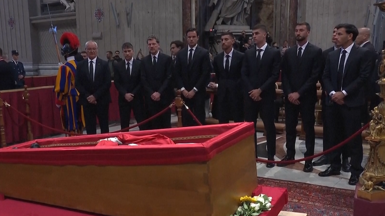 Claudio Ranieri (left of line) and players from his side Roma, pay their respects to the Pope.
Pic: AP