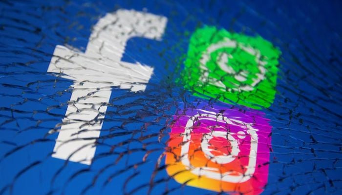 Facebook, Whatsapp and Instagram logos are displayed through broken glass in this illustration taken October 4, 2021. — Reuters