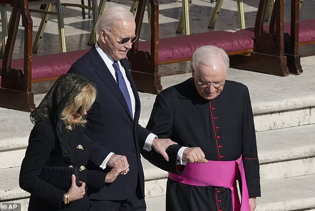 Former President Biden was seen gripping his wife Jill and a priest as he walked down a set of steps at Pope Francis's funeral on Saturday