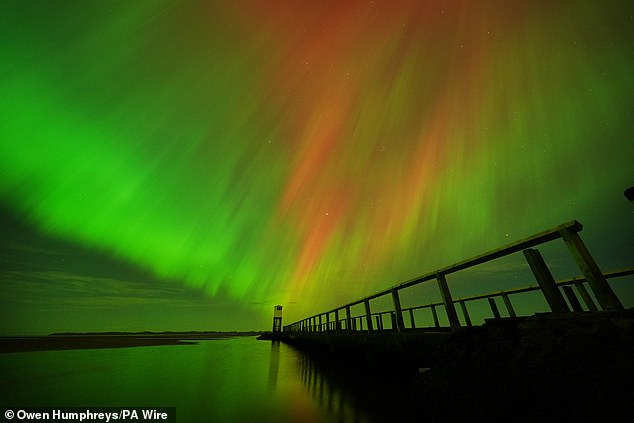 Also known as the aurora borealis, the colourful light show which turns the sky various fluorescent shades should be visible in parts of the UK. Pictured, aurora from Northumberland, October 11, 2024
