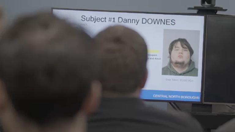 Armed Met Police officers receive a briefing before a dawn raid to arrest Danny Downes
