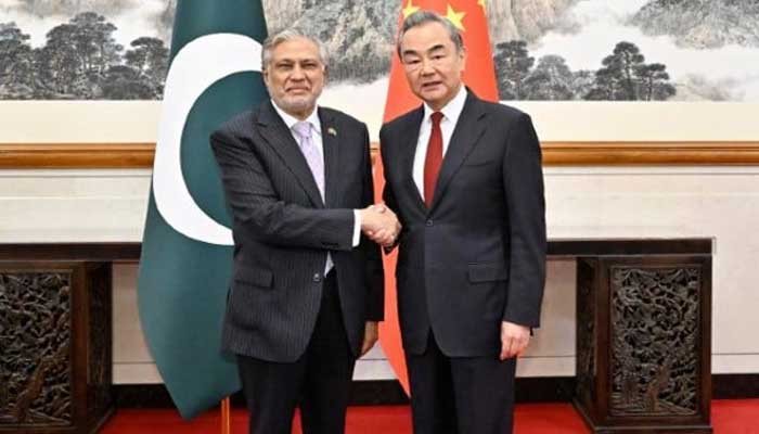 Deputy Prime Minister and Foreign Minister, Ishaq Dar (left) shakes hand with China’s Minister of Foreign Affairs Wang Yi. — APP/File