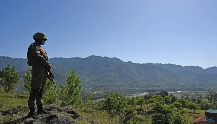 A Pakistani soldier stands guard near the Line of Control (LoC) at Salohi village in Poonch district of AJK on April 26, 2021. — AFP