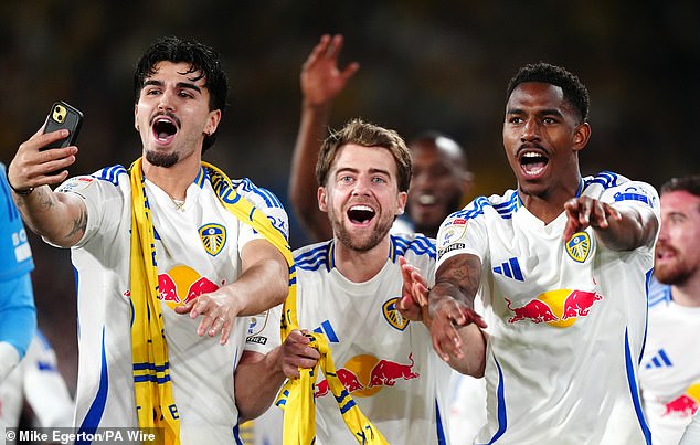 Patrick Bamford (centre), who put £5,000 behind the bar for punters, celebrates Leeds United's promotion from the Championship alongside Pascal Struijk and Junior Firpo (right)