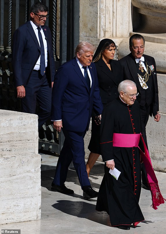U.S President Donald Trump and first lady Melania Trump walk to attend  the funeral Mass of Pope Francis, at the Vatican, April 26, 2025. REUTERS/Kai Pfaffenbach