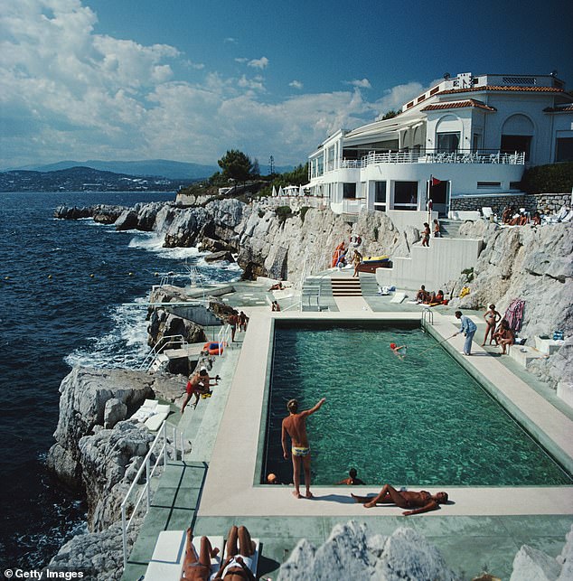 Guests at the swimming pool at the Hotel du Cap Eden-Roc, Antibes, France in August 1976