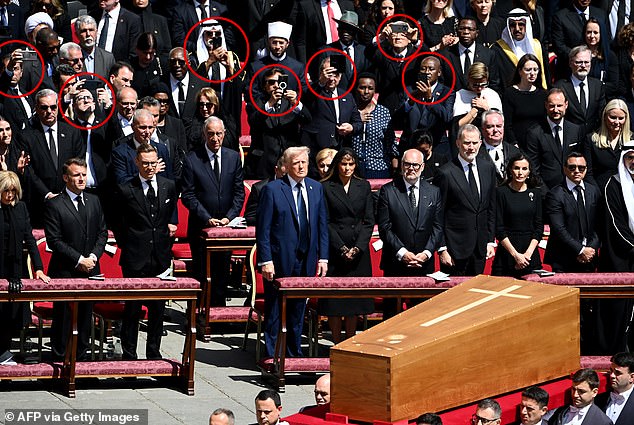 A number of dignitaries couldn't resist pulling out their mobiles to take pictures and videos of the late Pope's humble wooden casket