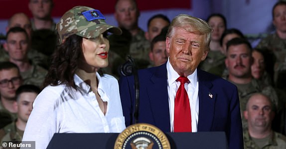 Michigan Governor Gretchen Whitmer speaks while standing next to U.S. President Donald Trump during an event at Selfridge Air National Guard Base in Harrison Township, Michigan, U.S., April 29, 2025. REUTERS/Evelyn Hockstein