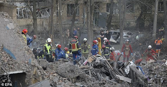 epaselect epa12050898 Ukrainian rescuers work at the site of a rocket strike that hit a residential building in Kyiv, Ukraine, 24 April 2025, amid the ongoing Russian invasion. Russia launched a large-scale overnight attack using a combination of drones and various types of rockets. At least nine people were killed and 63 others injured, including six children, in the strike on the residential building, according to the State Emergency Service report.  EPA/SERGEY DOLZHENKO