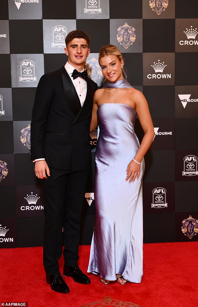 It came after he took aim at North Melbourne star Harry Sheezel (pictured with partner Mischa Rajch) claiming the youngster had been stat-padding