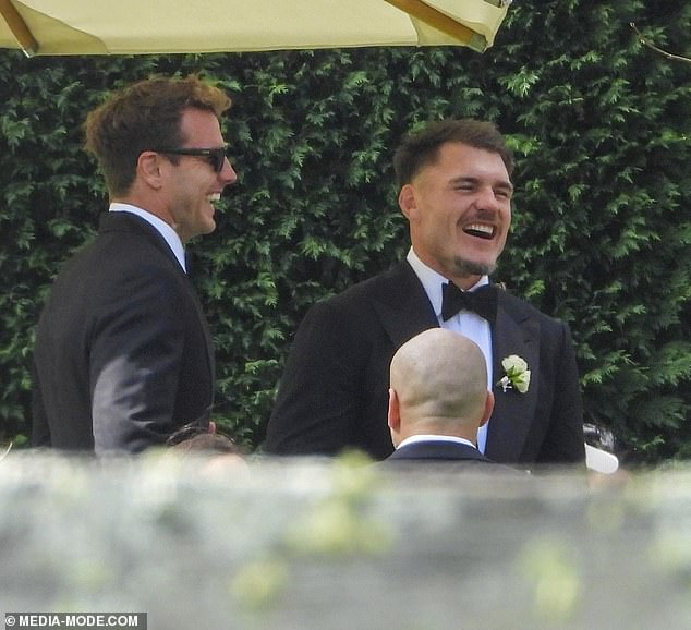 Crichton (right) laughed and joked with other members of the wedding party during the reception. He played the full 80 minutes of Friday's match, making 141 metres