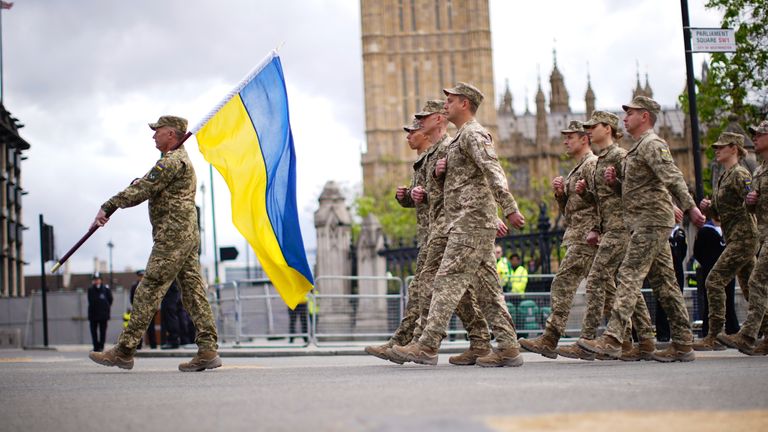 Members of the Ukrainian military march past the Palace of Westminster, during the VE Day 80th anniversary parade, in London, Monday, May 5, 2025. (James Manning/Pool Photo via AP)