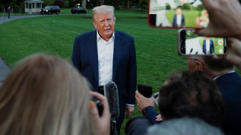 Donald Trump speaks to press as he arrives on the South Lawn of the White House in Washington.
Pic: Reuters