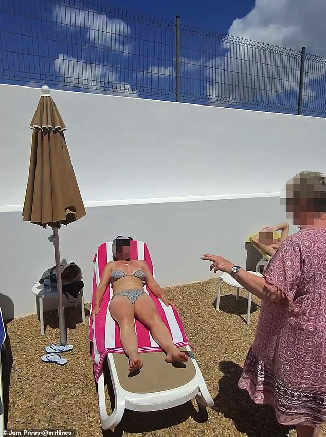 The two women are seen pointing at each other angrily during the poolside row