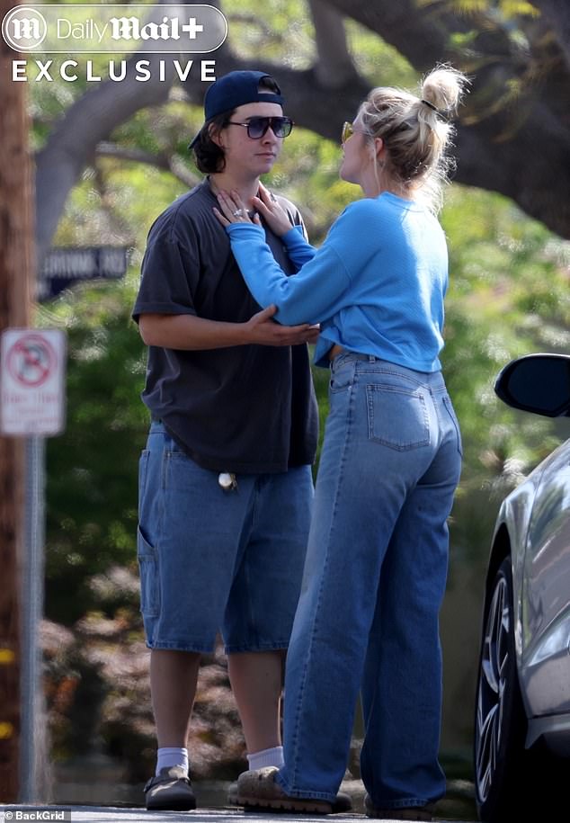 Camp wore a sky blue sweater with a complementary set of high-waisted jeans, sweeping her signature blonde hair up into a high bun