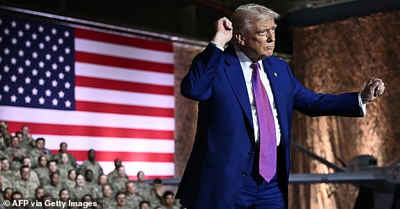 US President Donald Trump gestures as he arrives to address troops at the Al-Udeid air base southwest of Doha on May 15, 2025. (Photo by Brendan SMIALOWSKI / AFP) (Photo by BRENDAN SMIALOWSKI/AFP via Getty Images)
