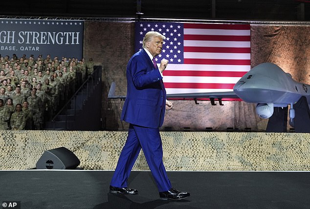 President Donald Trump pumps his fist on stage at the Al Udeid Air Base