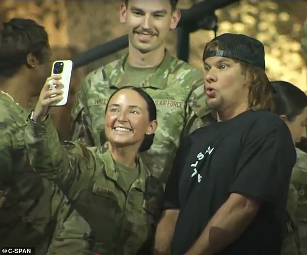 Podcaster and comedian Theo Von takes pictures with service members at Al-Udeid Air Base in Qatar